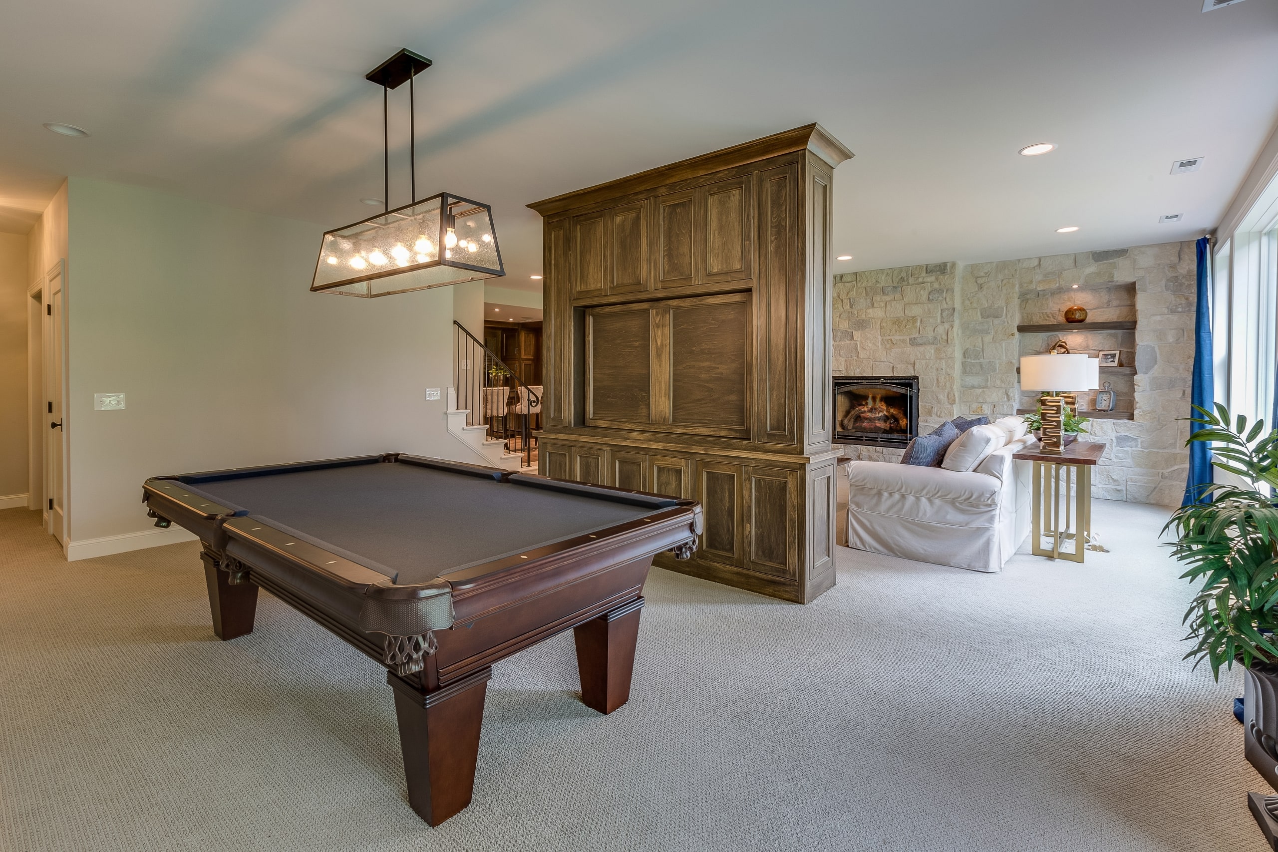 Basement with pool table and fireplace